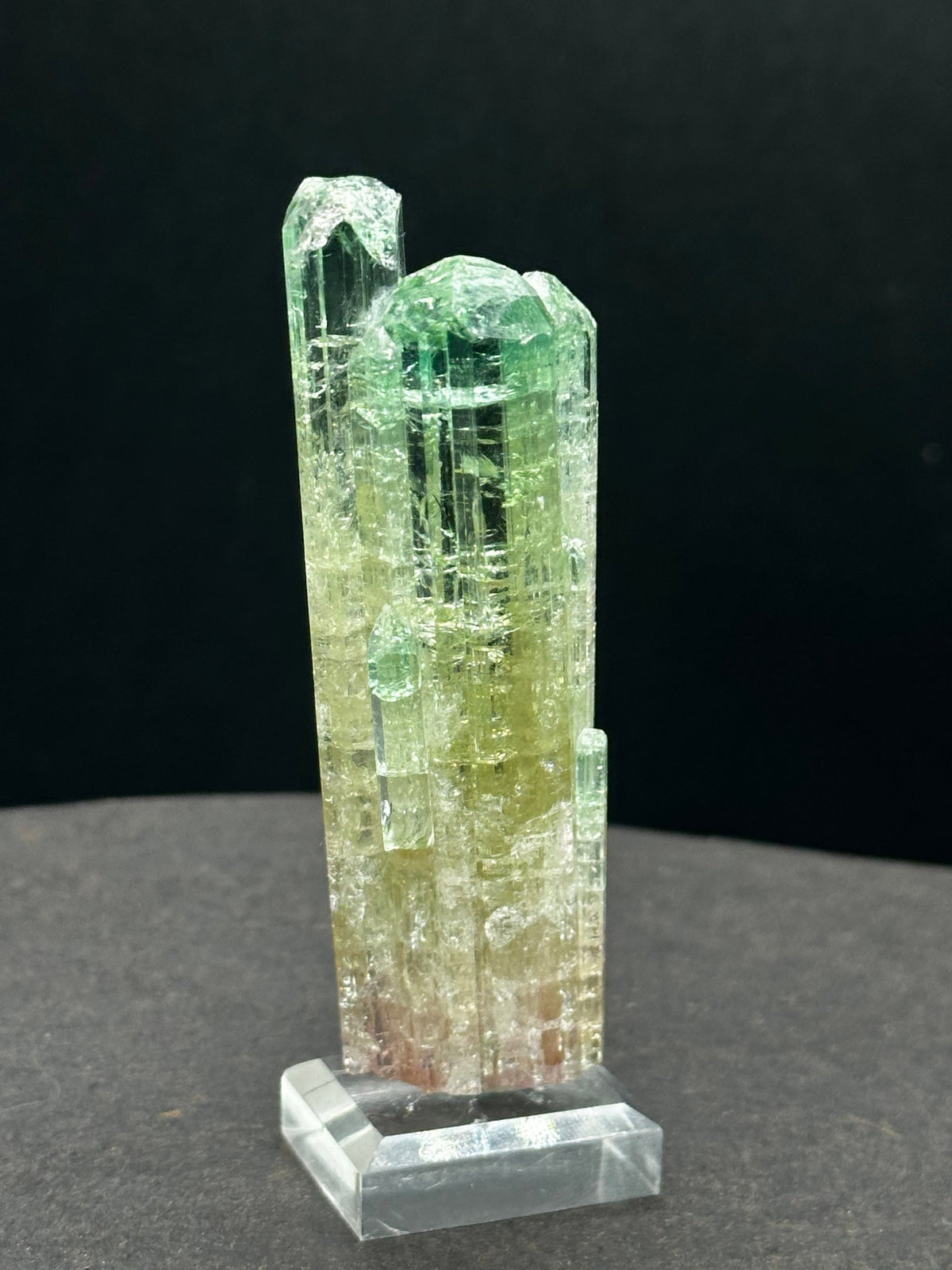 Multi-column watermelon tourmaline cluster in green, yellow and pink, on a stand, Pakistan