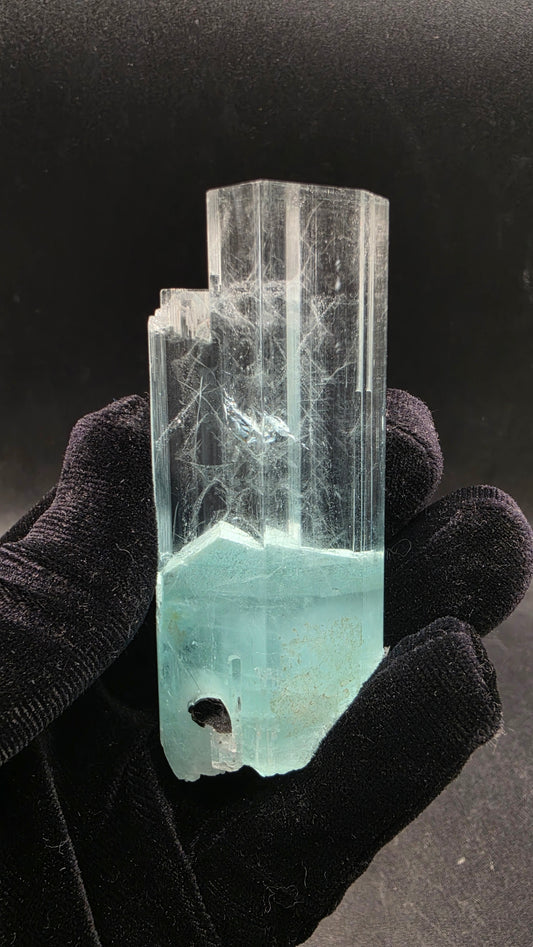 Large transparent bi-color aquamarine crystal with glacier-clear top and vivid seafoam blue base — gem-grade raw collector specimen with natural silk inclusions, ethically sourced from Pakistan